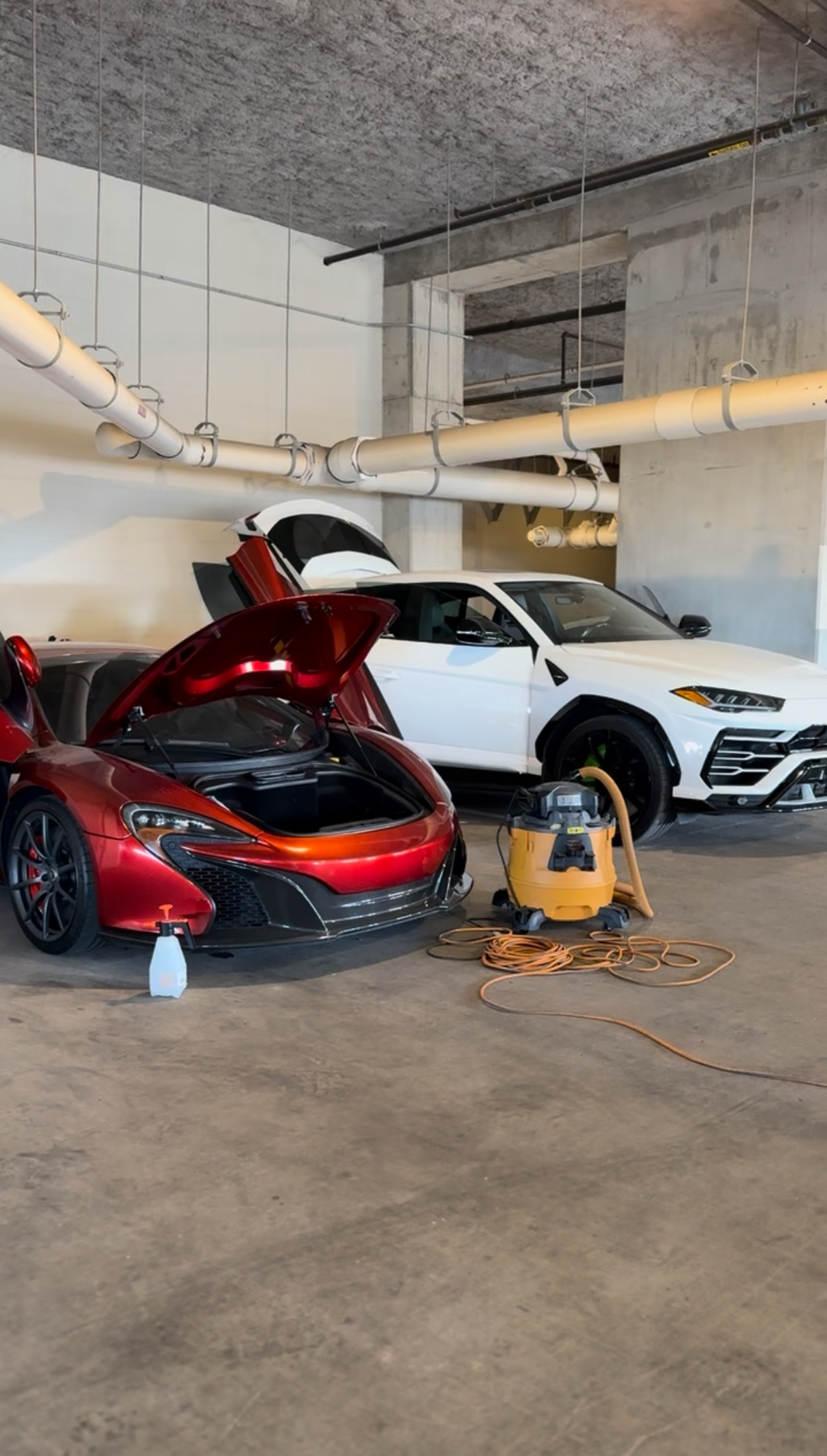 McLaren and Lamborghini Urus in detail bay